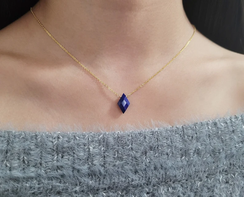 a woman wearing a lapis lazuli gemstone necklace