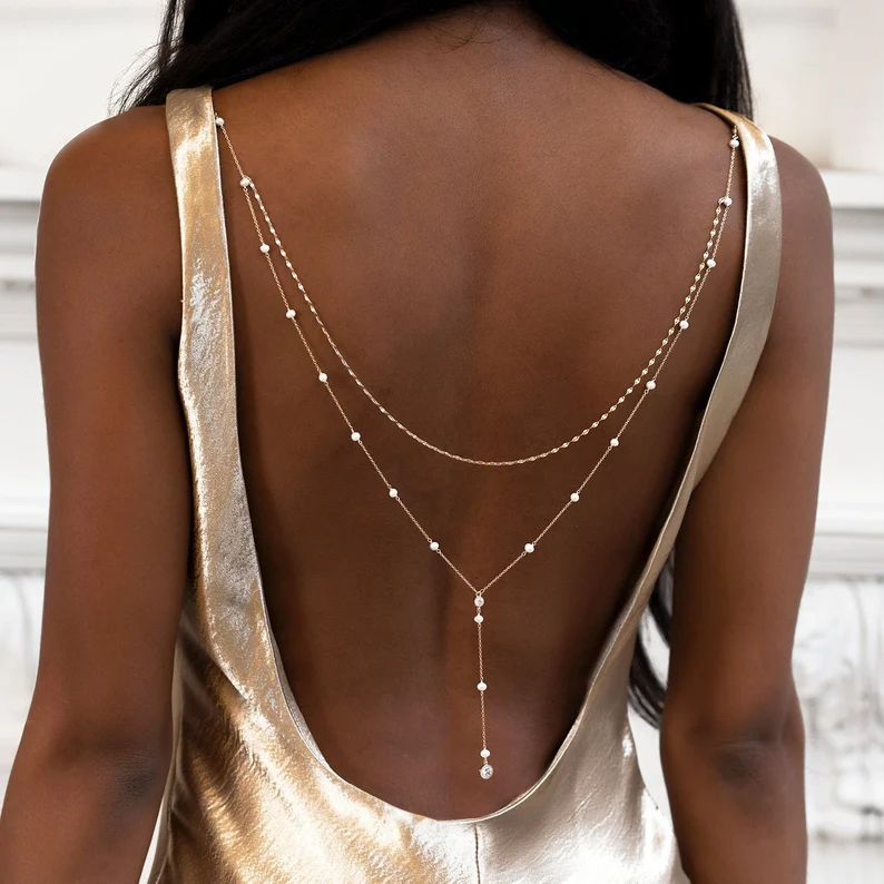 back view of a woman wearing a pearl backdrop necklace