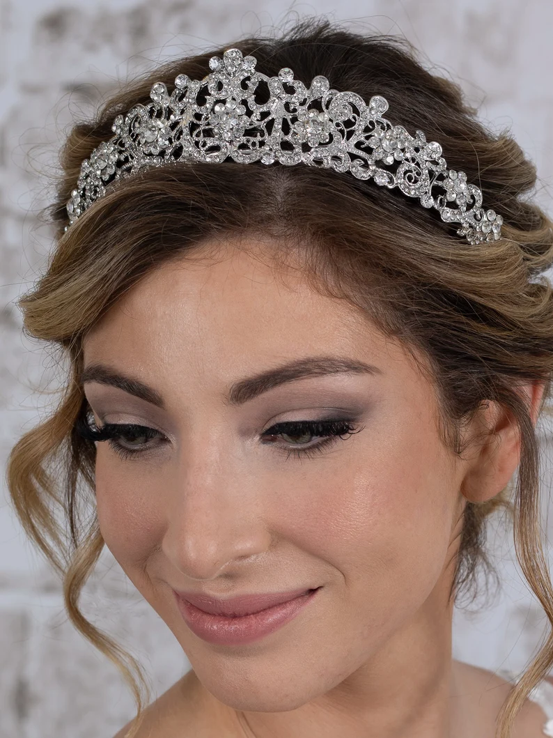 a woman wearing a silver rhinestone wedding tiara