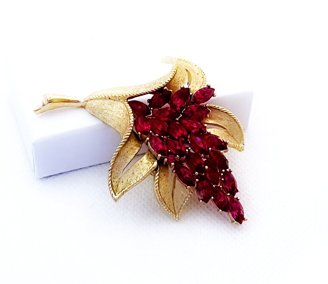 floral trifari brooch with red gemstones 
