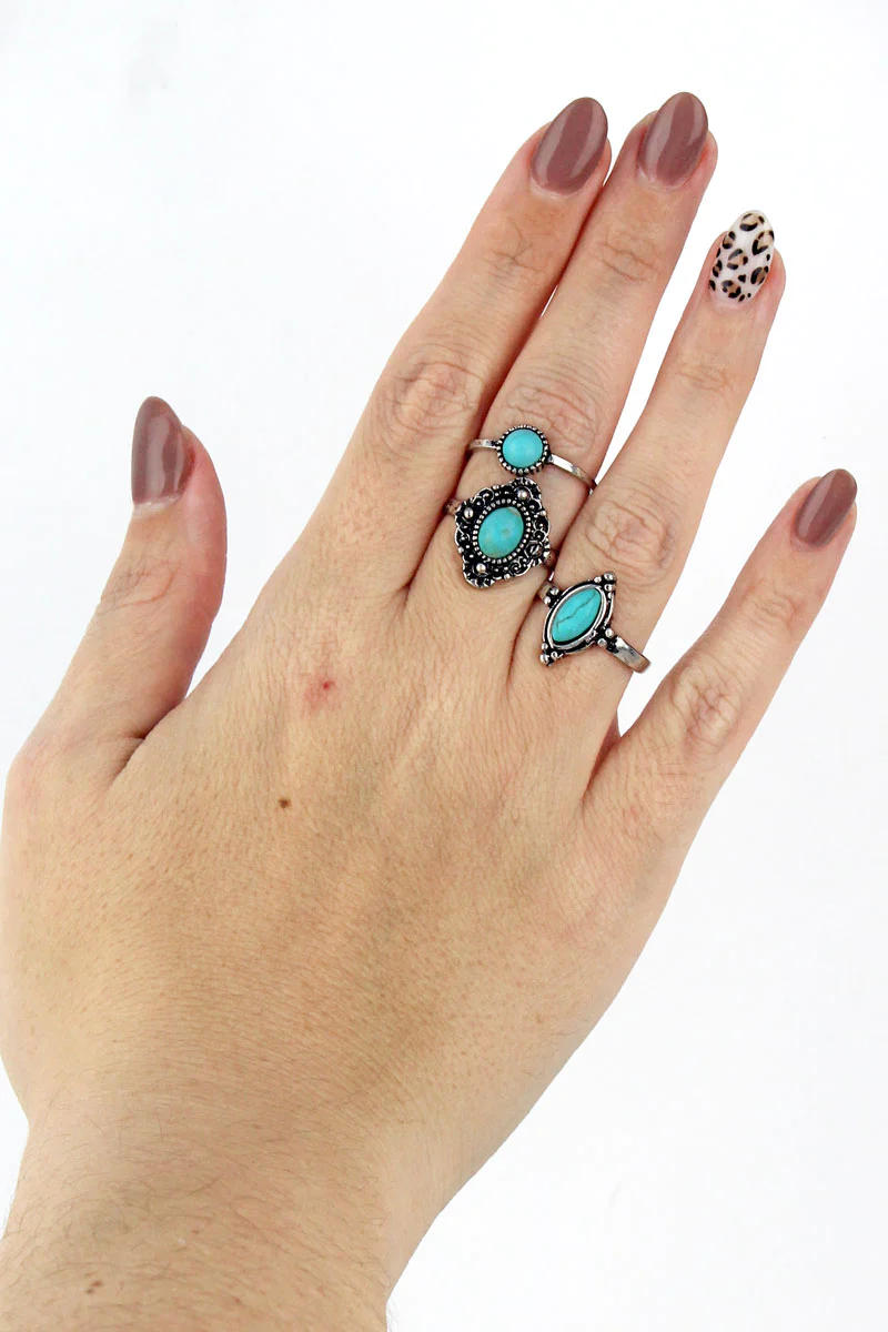 a hand with turquoise lorelei gemstone rings