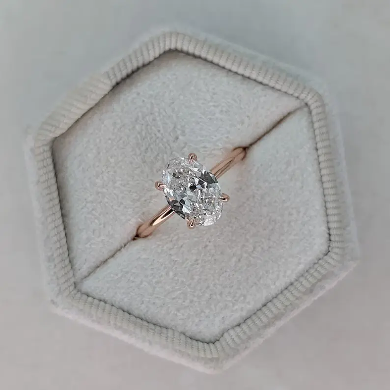 2 carat oval diamond engagement ring on white jewelry box