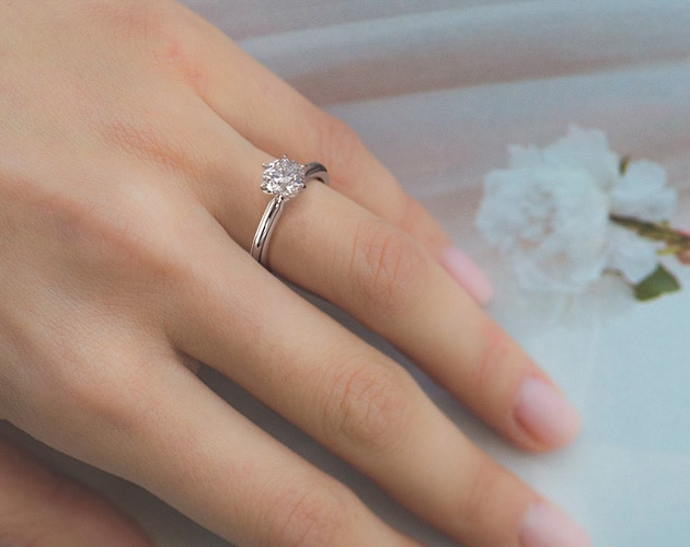 4.52 carat solitaire engagement ring on a finger