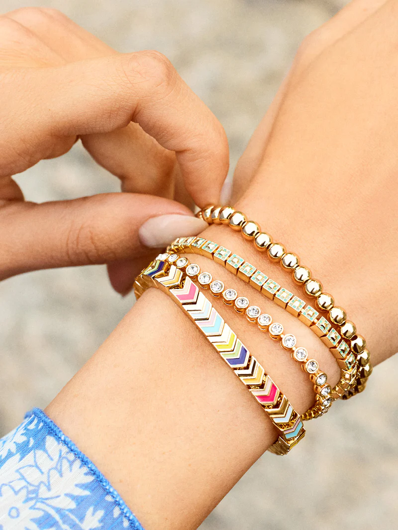 a woman wearing bracelets with different designs