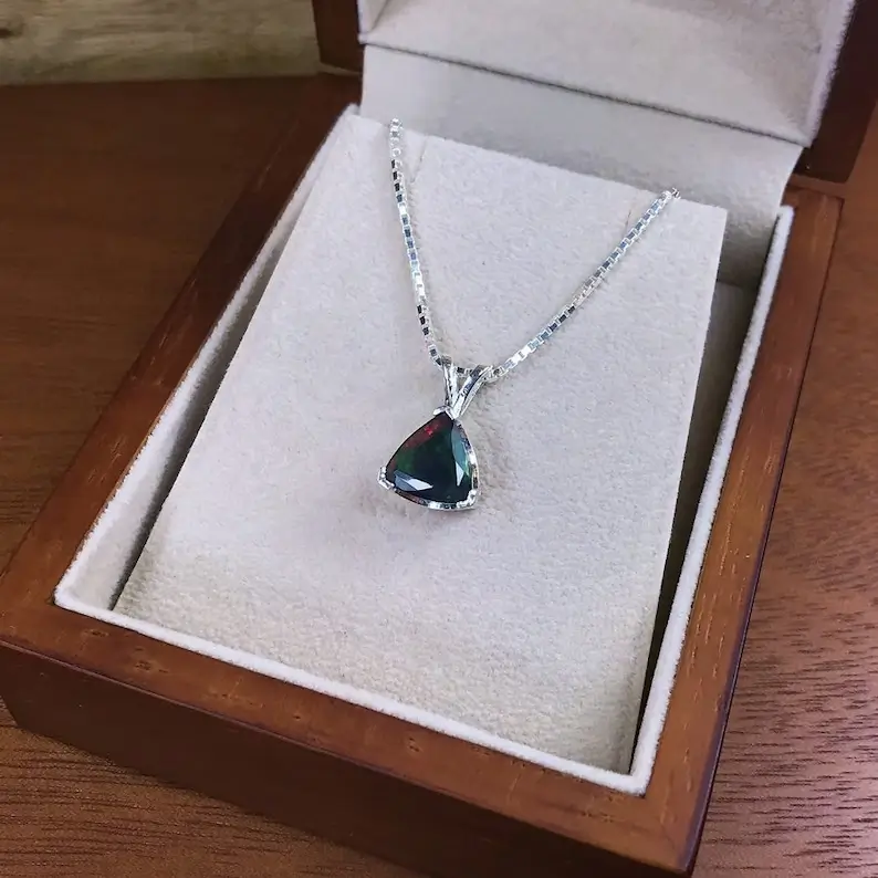 black opal pendant on a jewelry box
