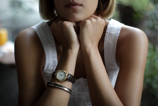 a woman wearing a brown casual watch