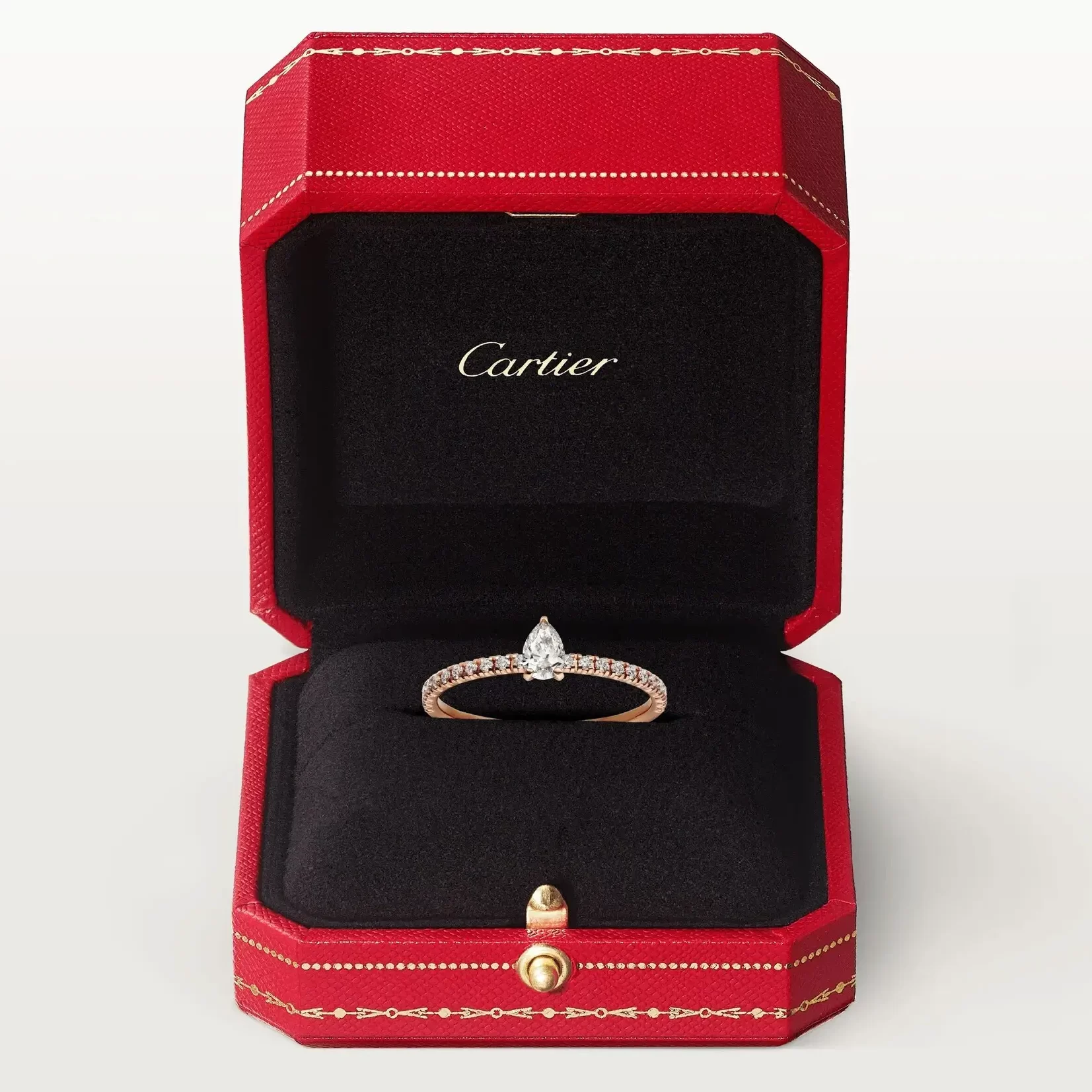 rose gold pear-shaped diamond ring in red jewelry box
