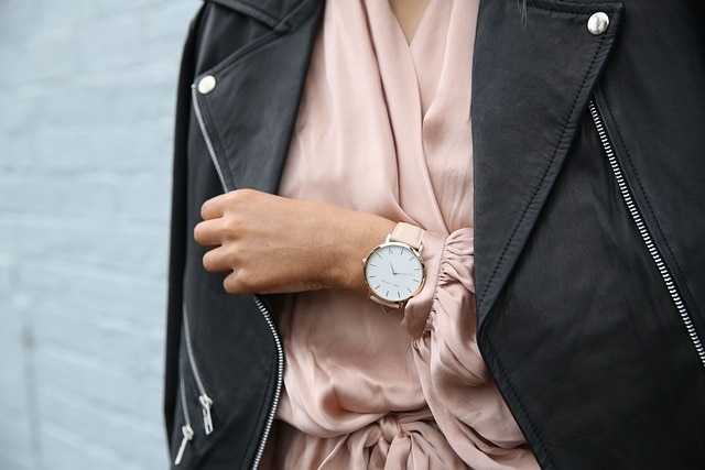 a woman wearing a formal pink leather watch