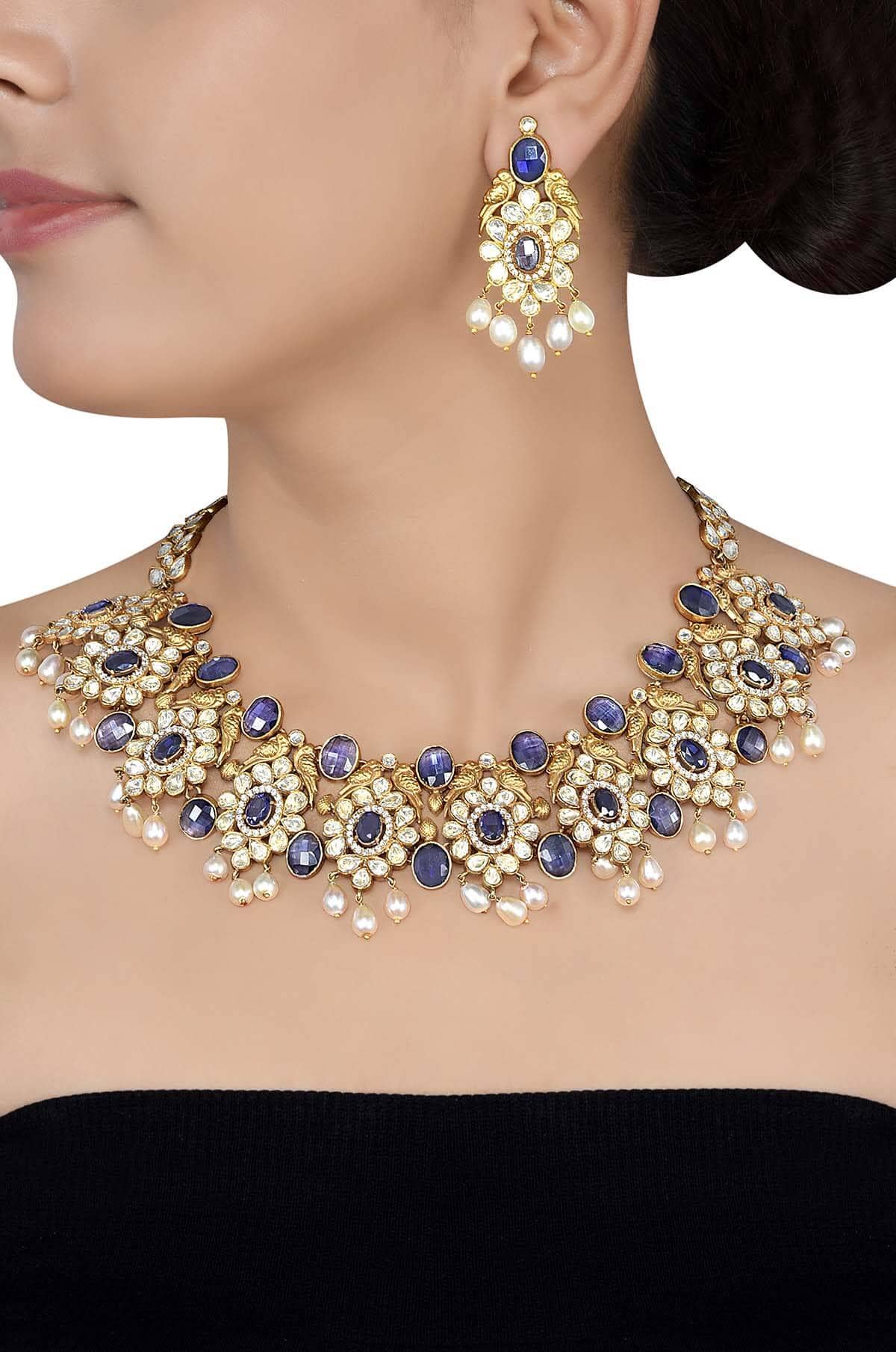a woman wearing gold plated silver necklace and earring