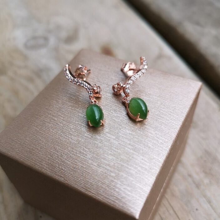 nephrite jade drop earrings on top of a brown box