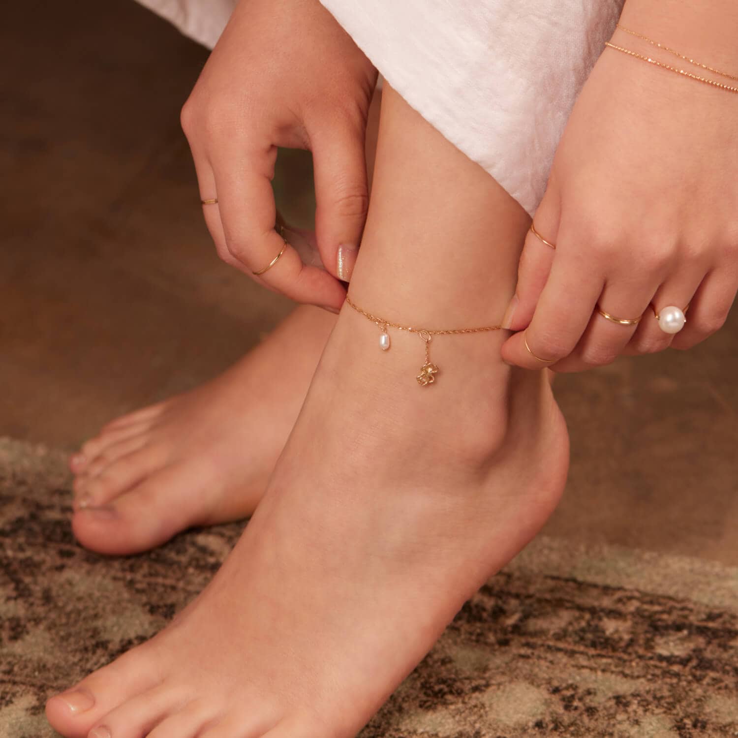 a woman wearing sweet nothing anklet