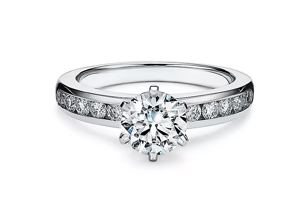 tiffany setting engagement ring with channel set diamond band