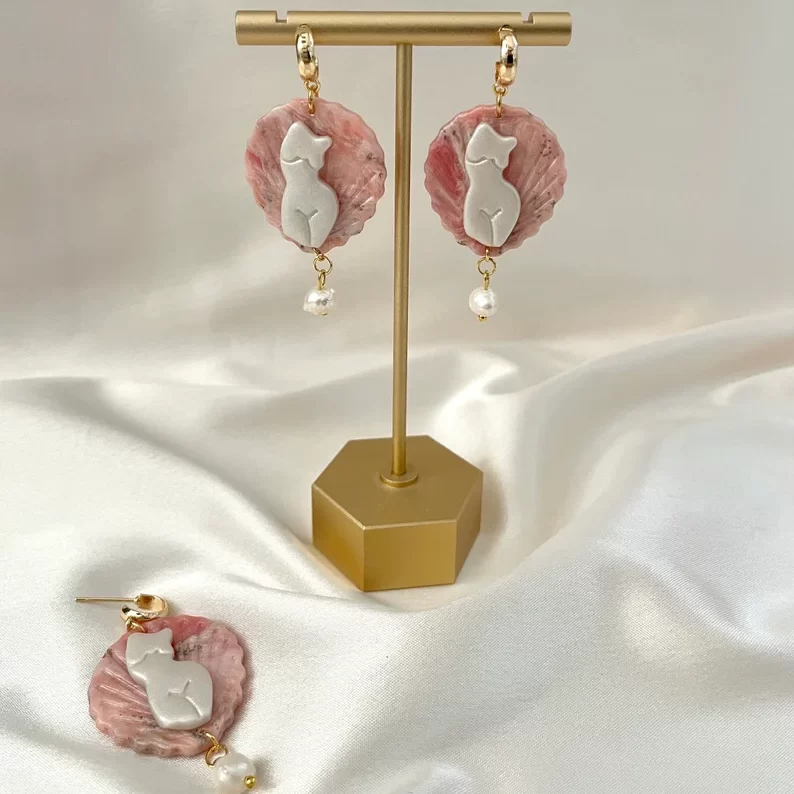 venus mythology pearl earrings on a gold earrings stand