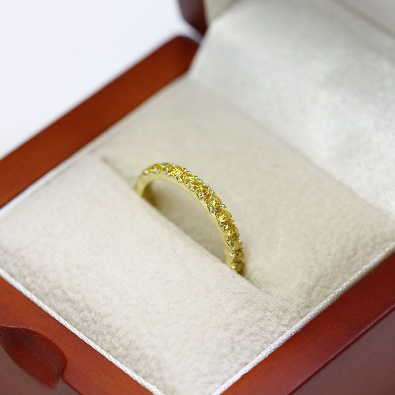 yellow diamond eternity ring in a red jewelry box