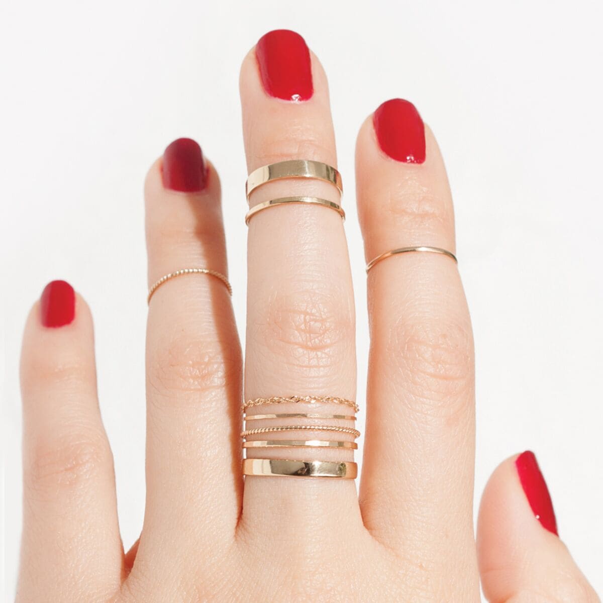 fingers with yellow gold stacked rings