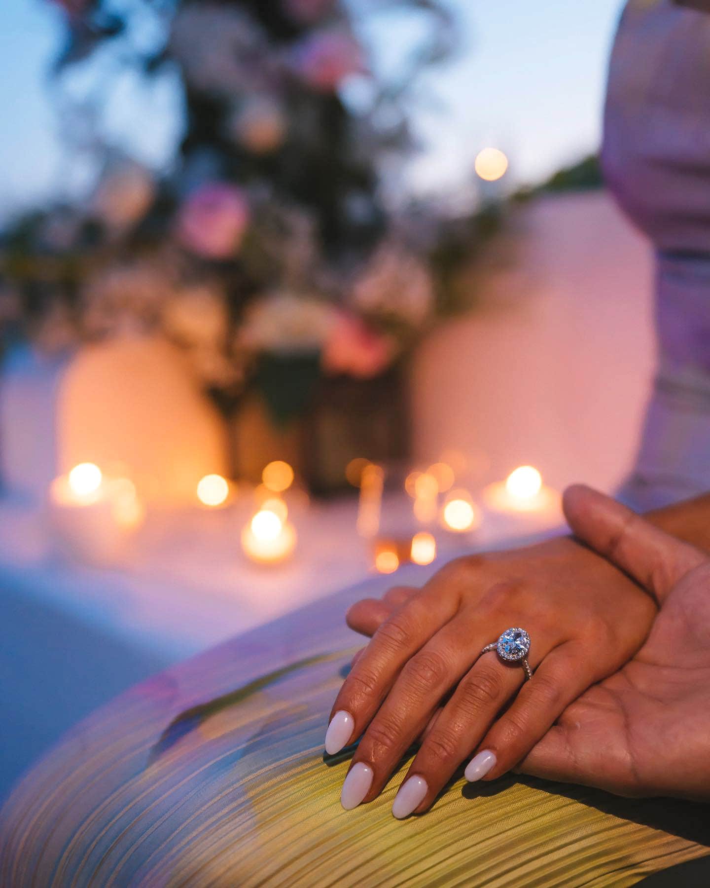 woman wearing diamond ring with halo setting
