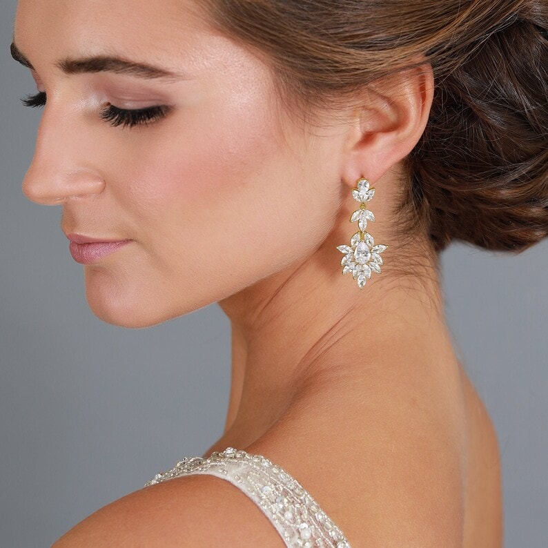 side view of a woman wearing a gold bridal earring