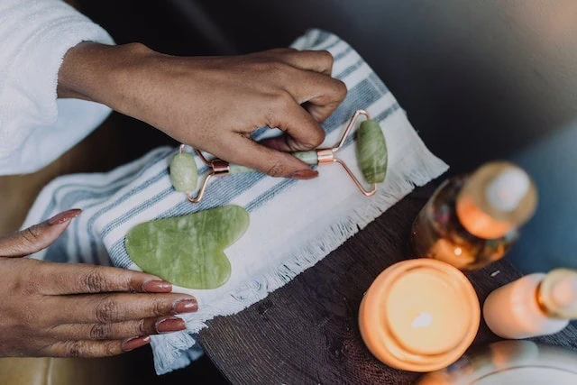 a woman holding a roller jade