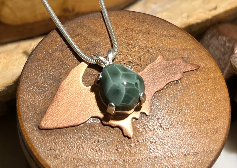 large greenstone necklace necklace on a wood
