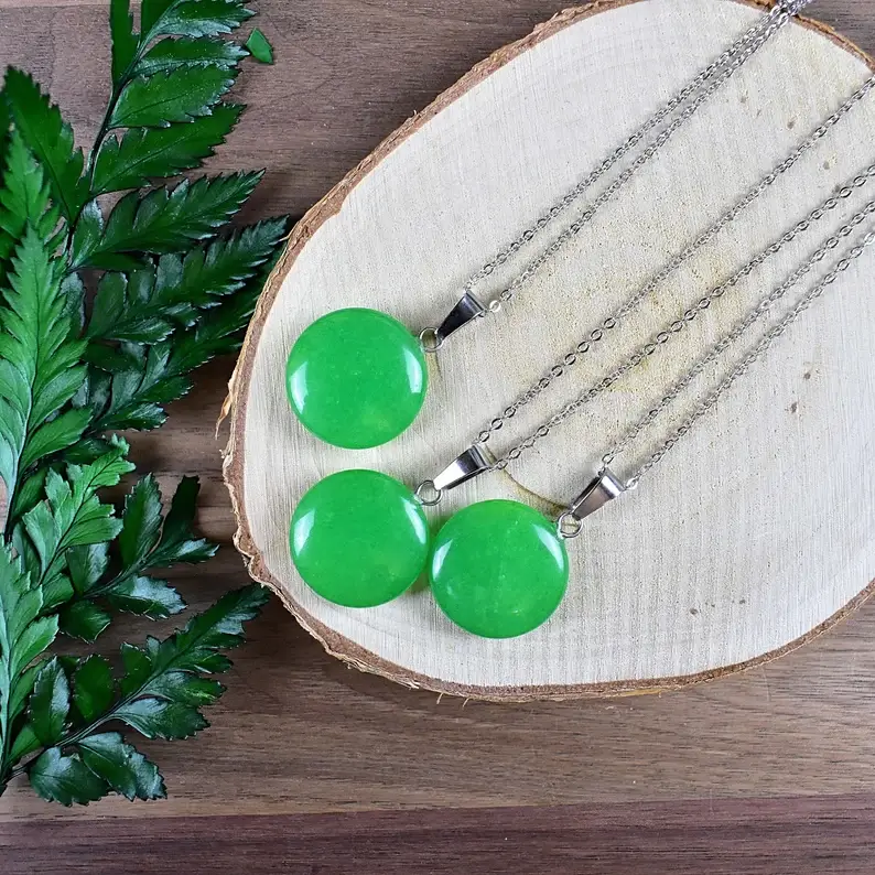 round malaysian jade necklaces on top of a wood
