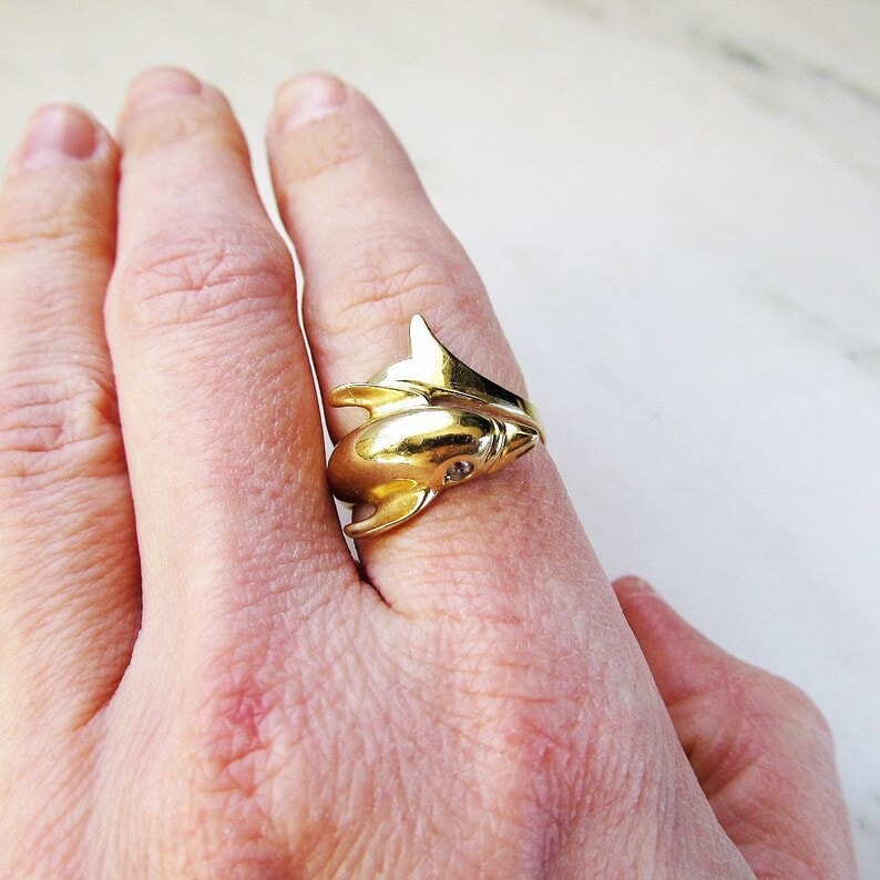 vintage diamond dolphin ring on a finger