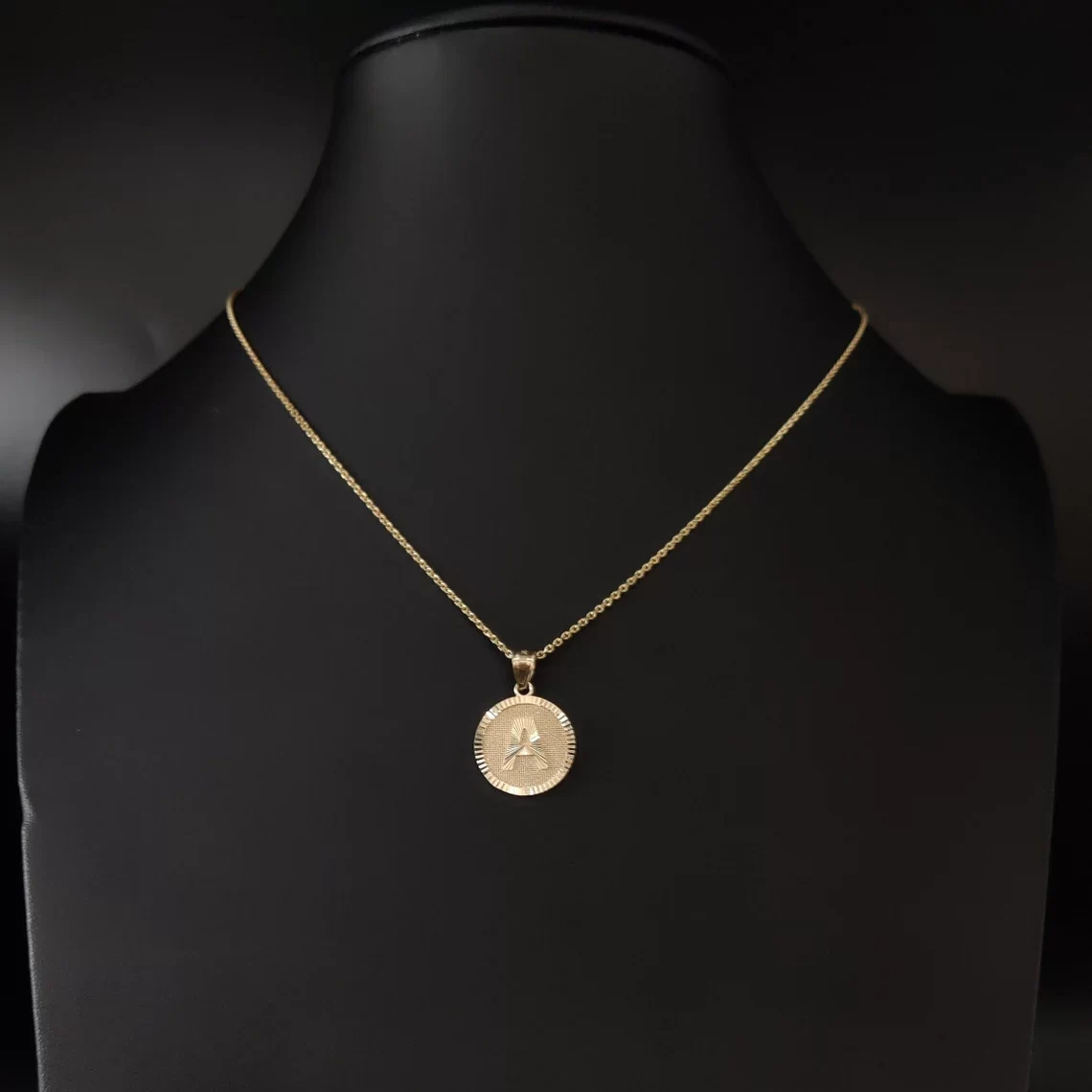 10k gold initial necklace on a neck maneqquin