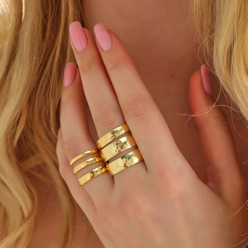 10k gold hammered wedding bands on the woman's fingers