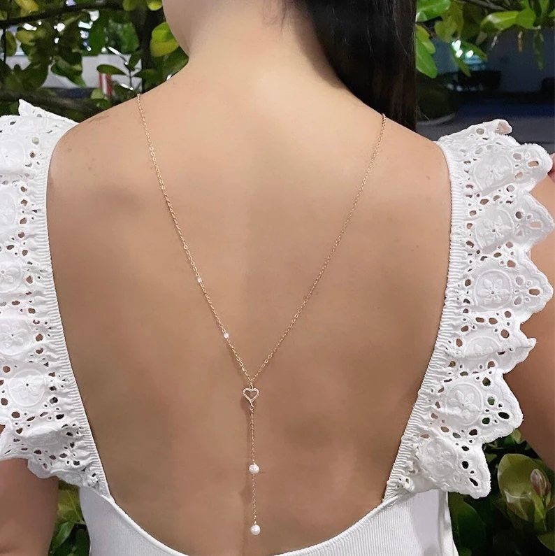 a back drop pearl necklace on a woman's back