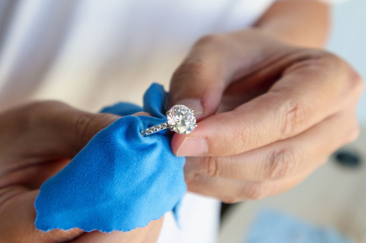 a man cleaning a cubic zirconia ring
