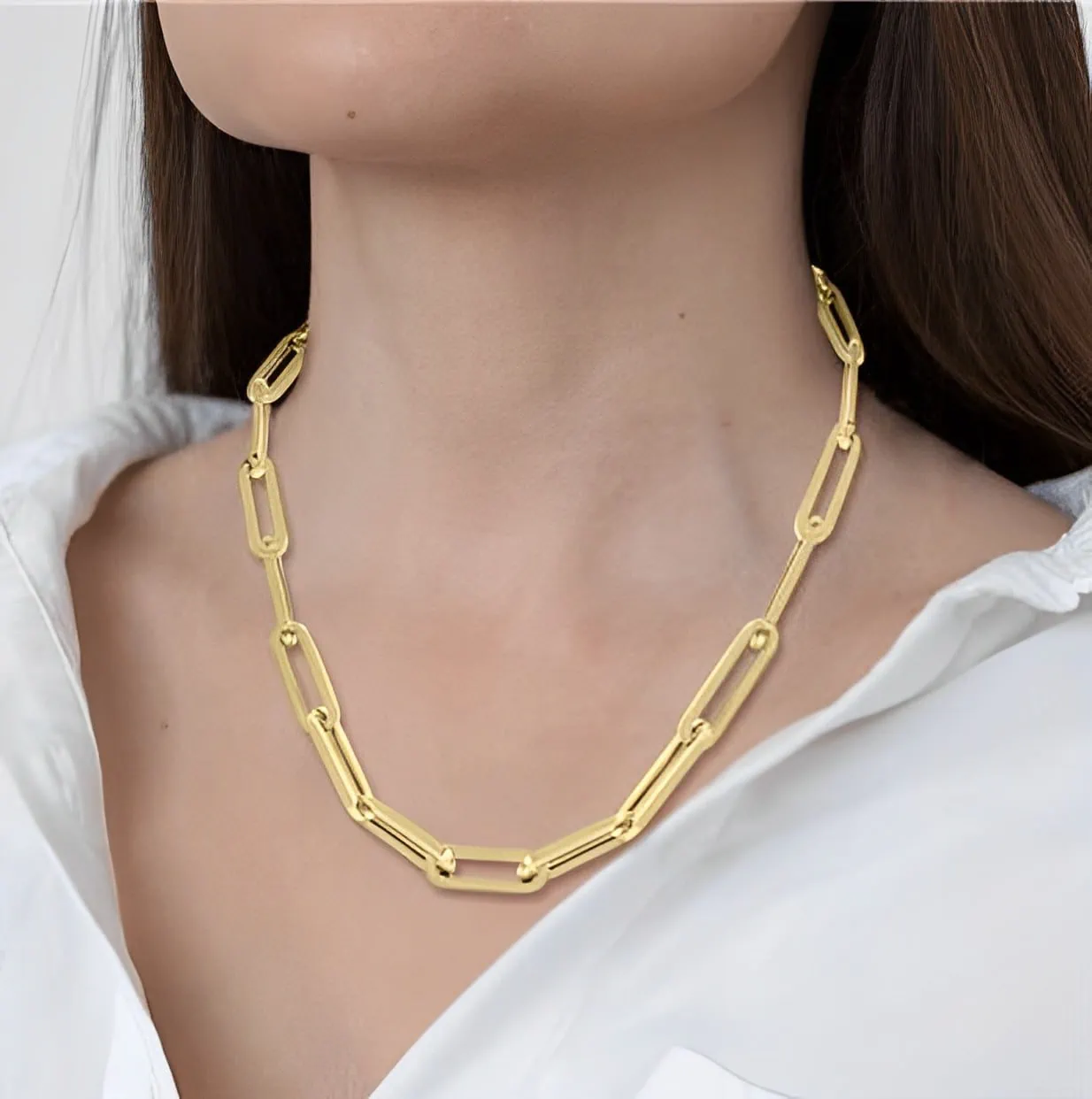 gold chunky paperclip chain necklace on a woman's neck