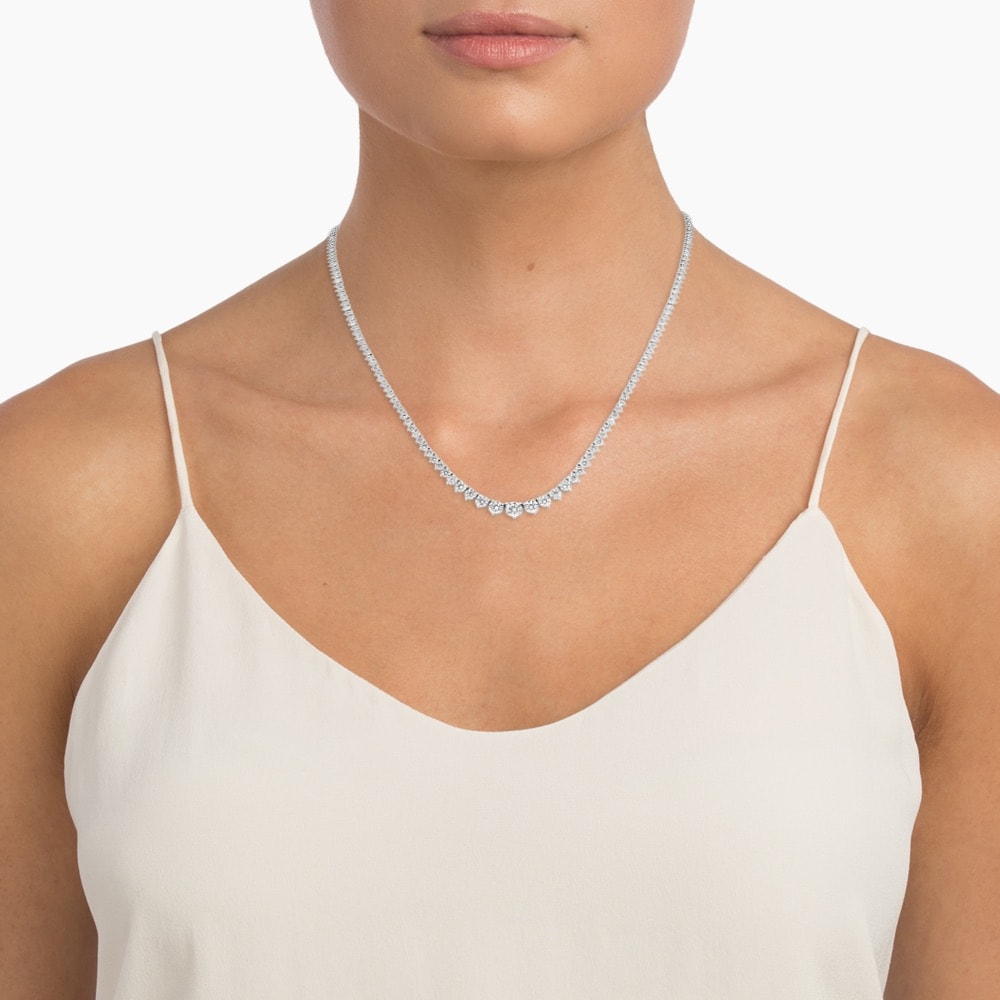 a woman wearing a riviere tennis necklace