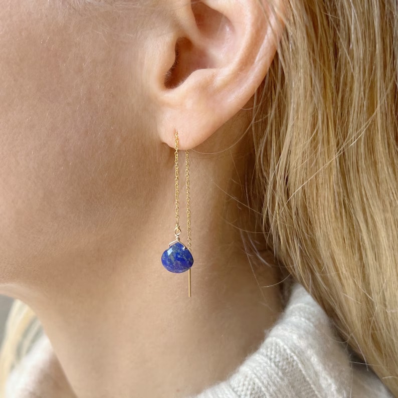 lapis lazuli dangle earring on the woman's ear