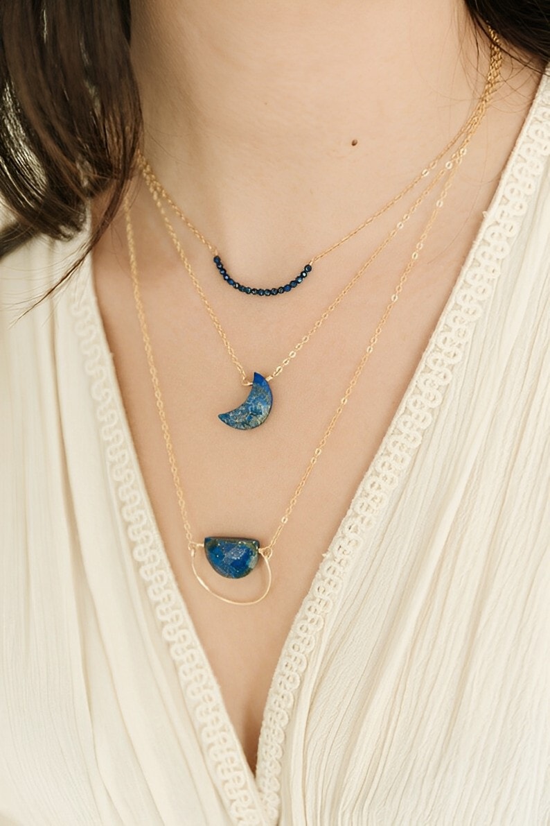 lapis lazuli pendant necklaces on the woman's neck