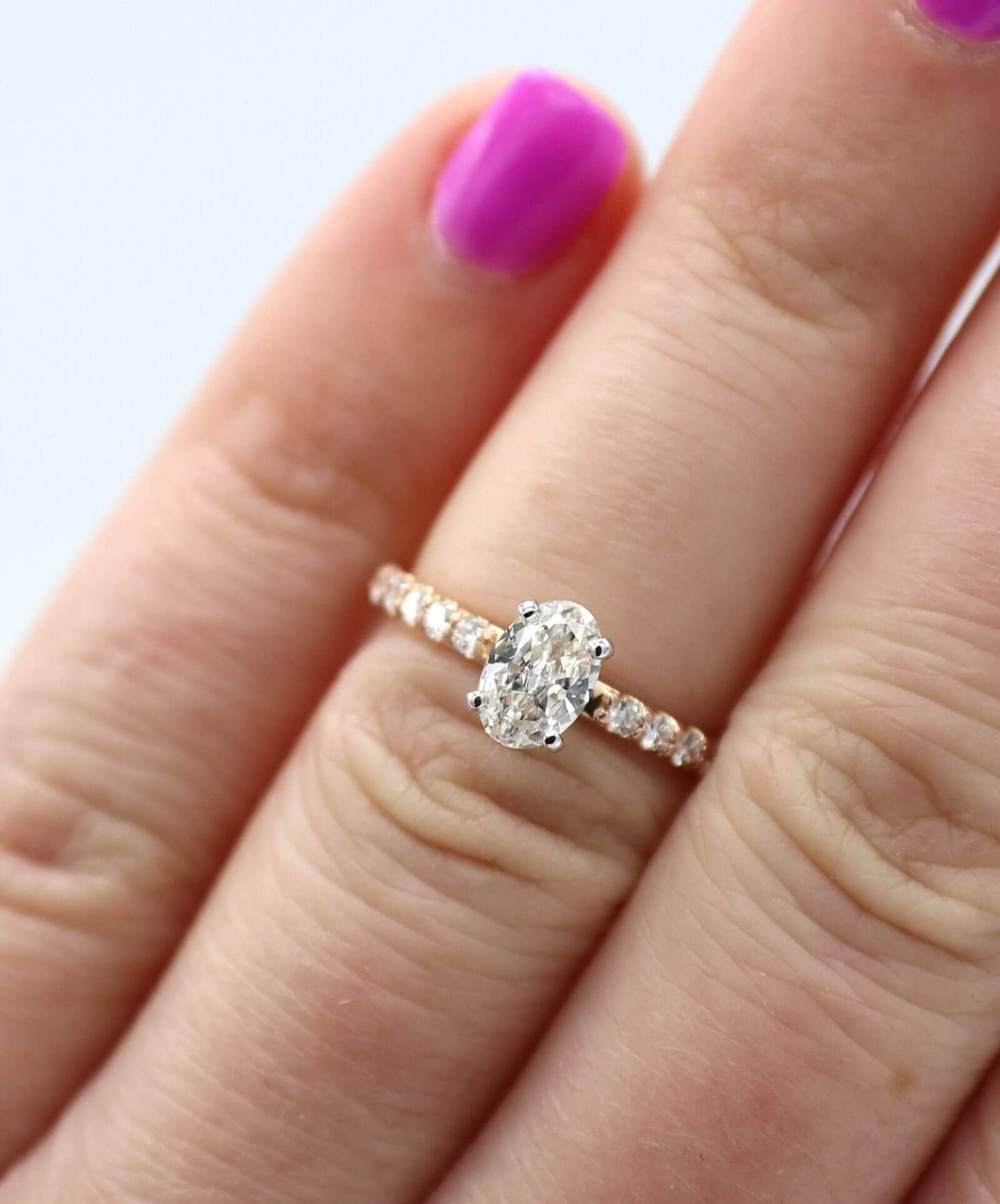 oval diamond engagement ring on the ring finger