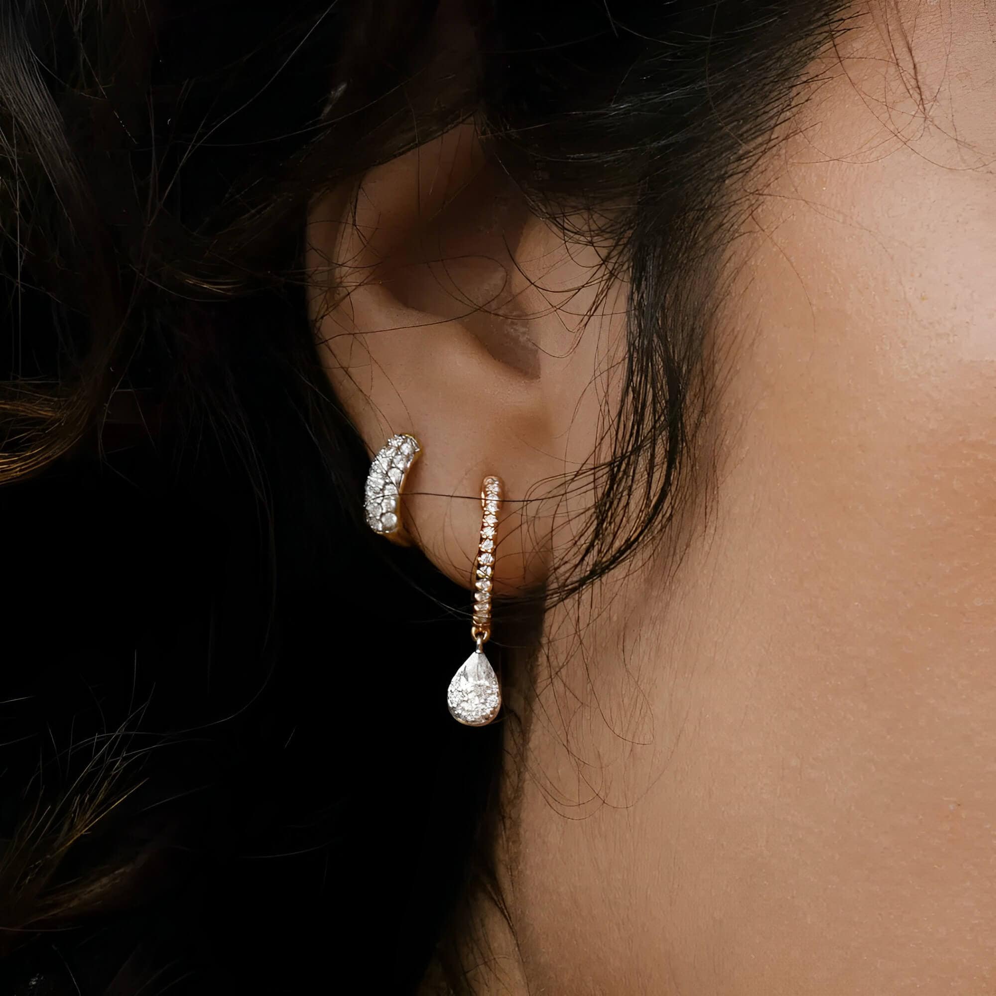 pave huggie hoop earrings on the woman's ear