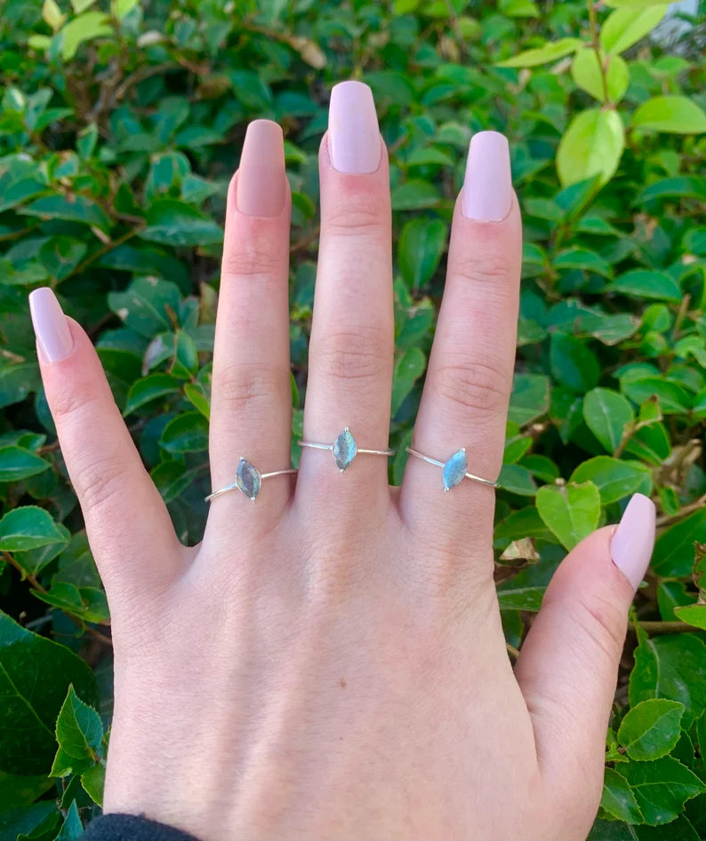 polished labradorite marquise rings on fingers