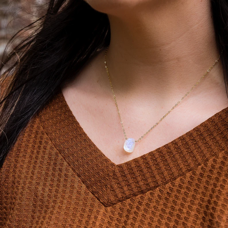raw moonstone necklace on the woman's neck