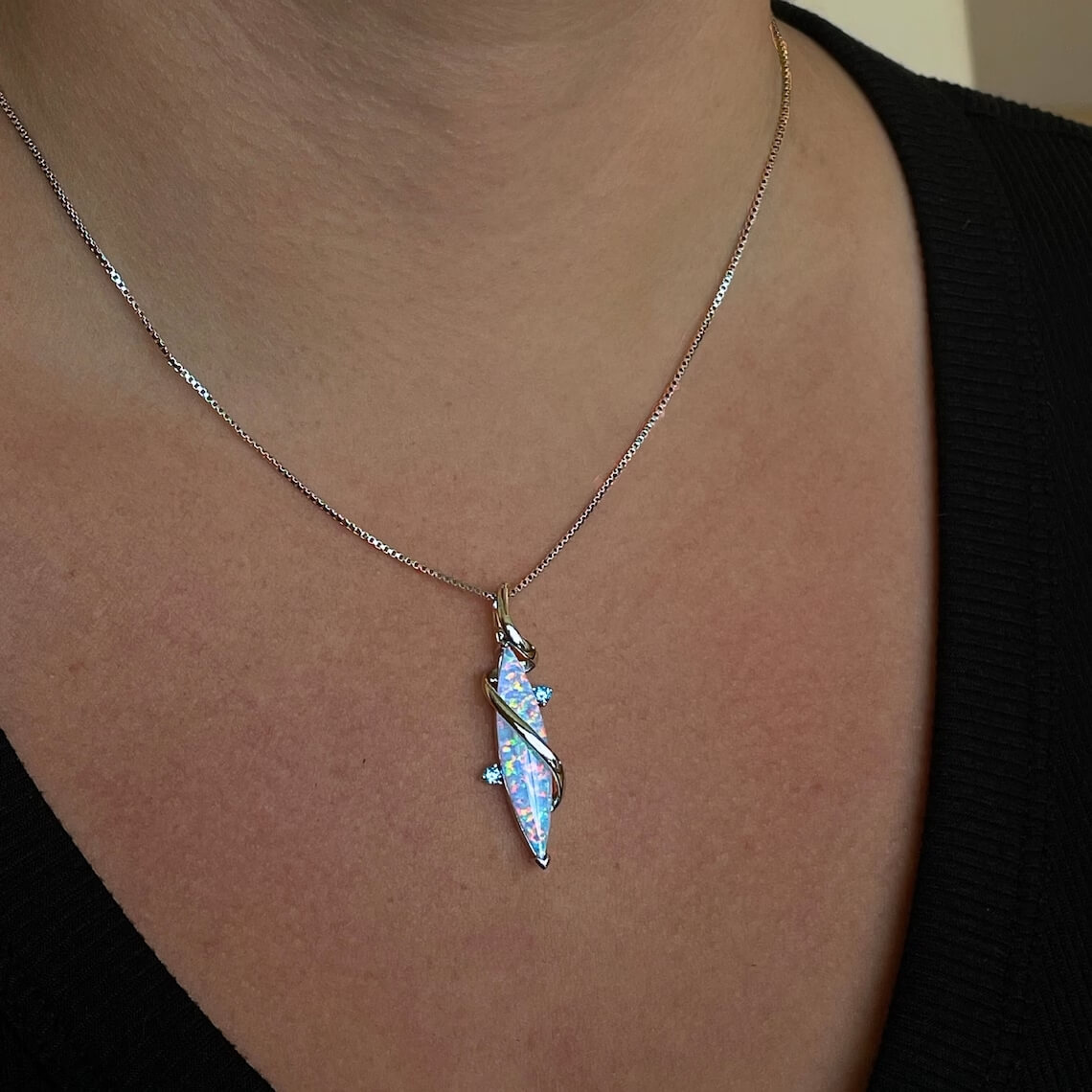 silver opal pendant necklace on the neck