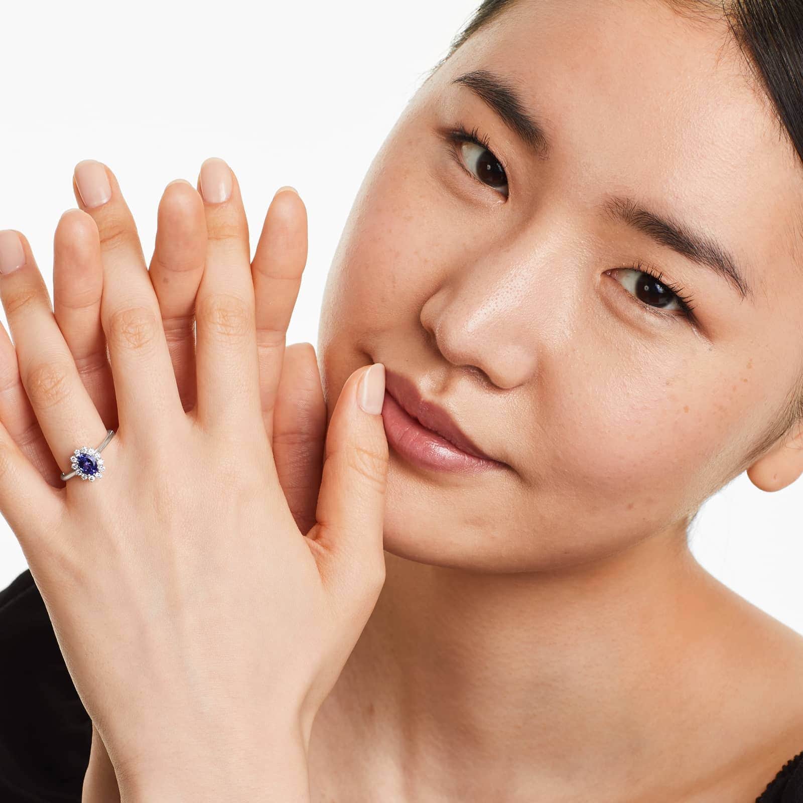 sunburst tanzanite and diamond ring on the woman's ring finger