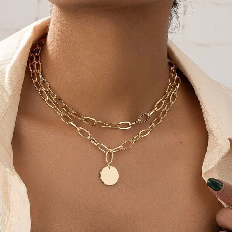 a woman wearing vintage gold chain layered necklace