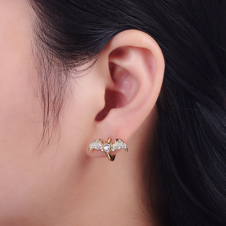 bat design earring on the woman's ear