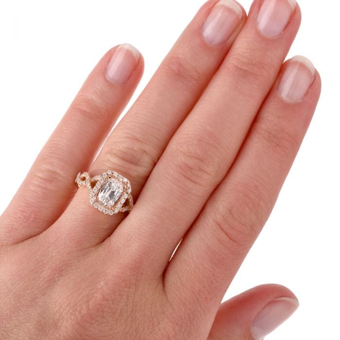 cushion cut diamond engagement ring on the ring finger