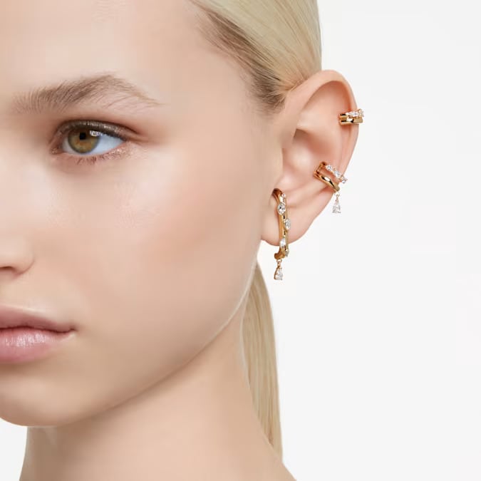swarovski gold ear cuff earrings on the woman's ear