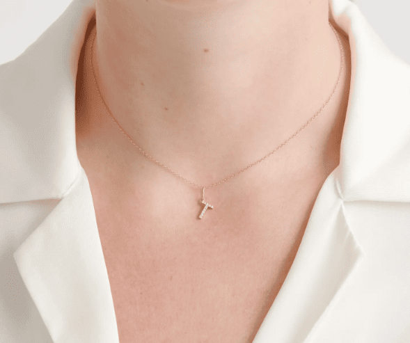diamond letter pendant necklace on the neck