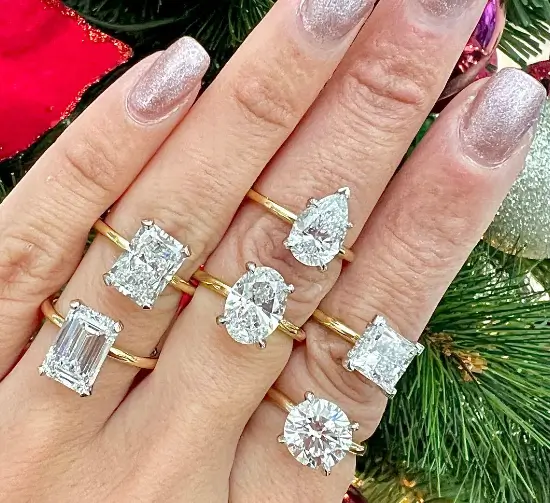 diamond solitaire engagement rings on fingers