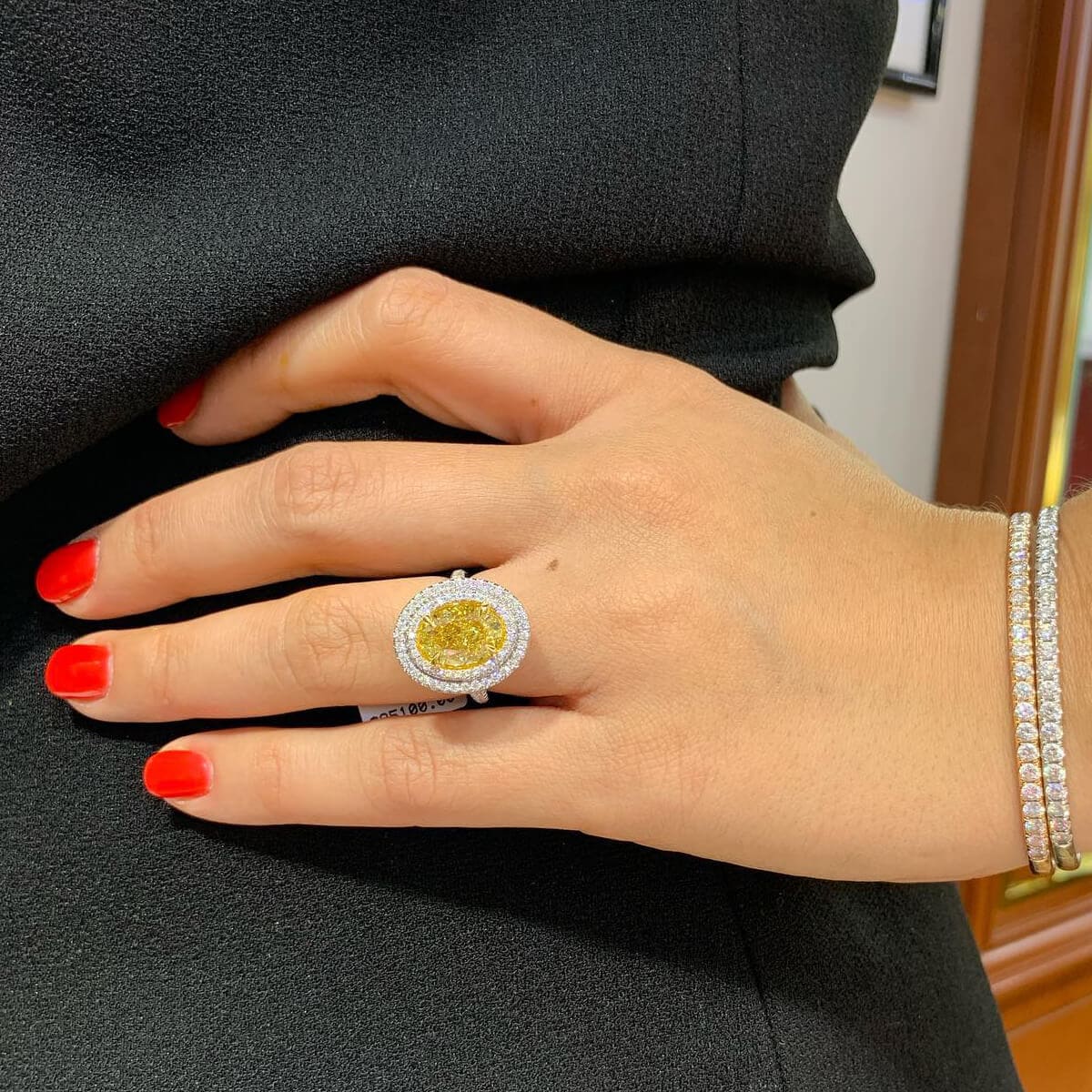 fancy yellow diamond engagement ring on the woman's ring finger