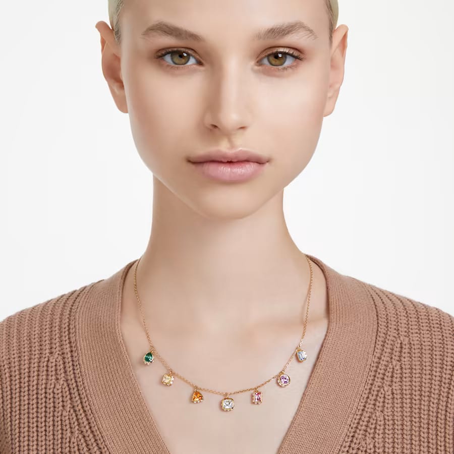 a woman wearing mixed cuts multicolored crystals necklace
