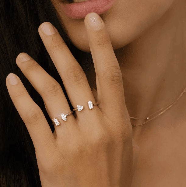 mixed diamond cuff rings on woman's fingers