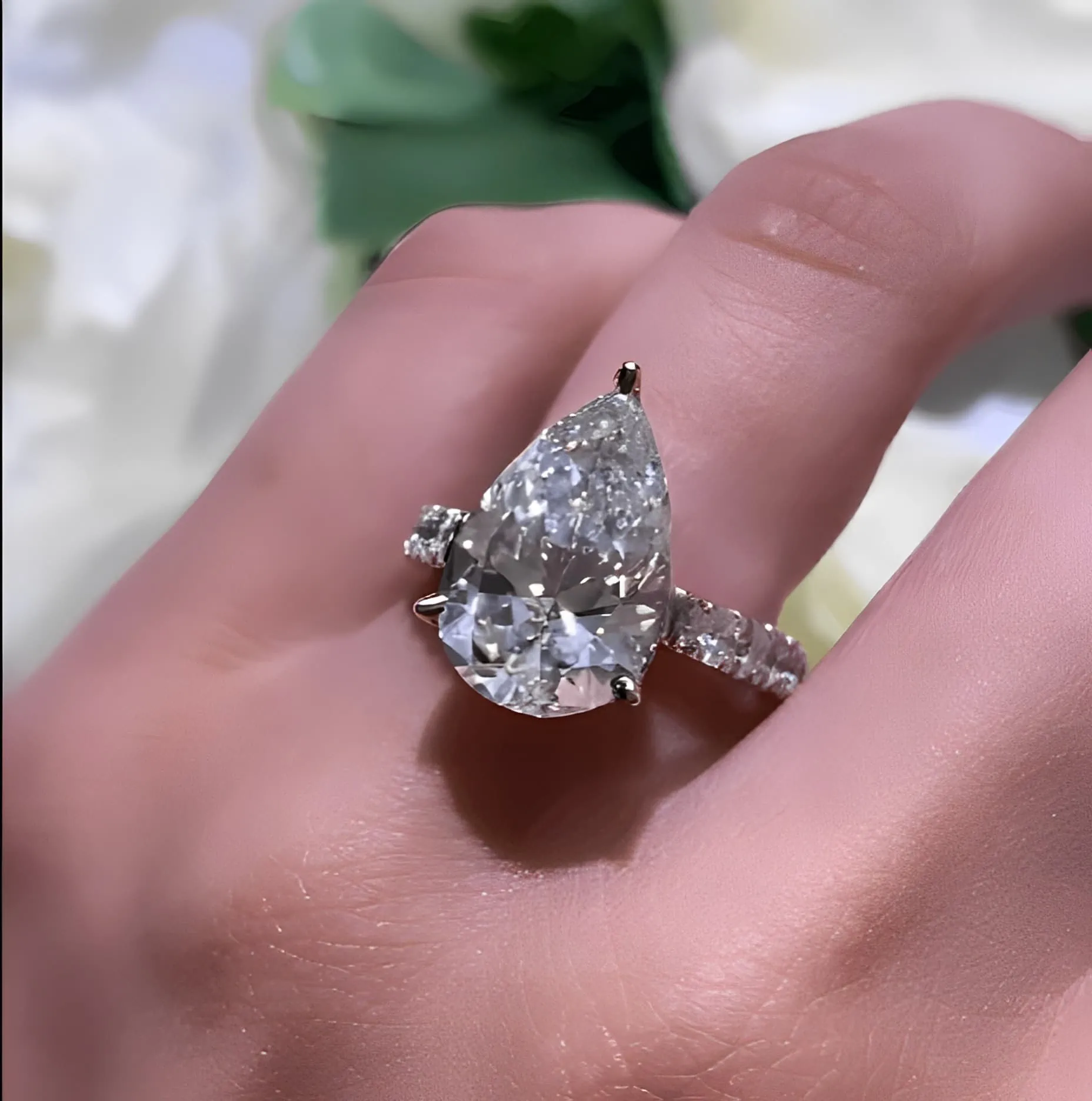 pear shape diamond engagement ring on the ring finger