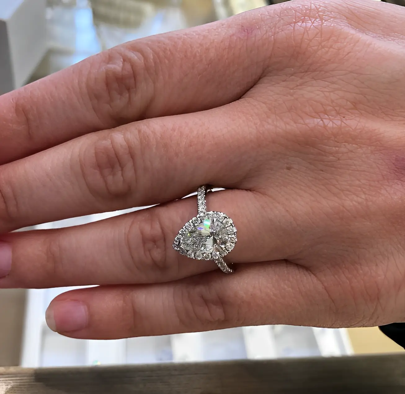 pear shaped diamond engagement ring on the ring finger